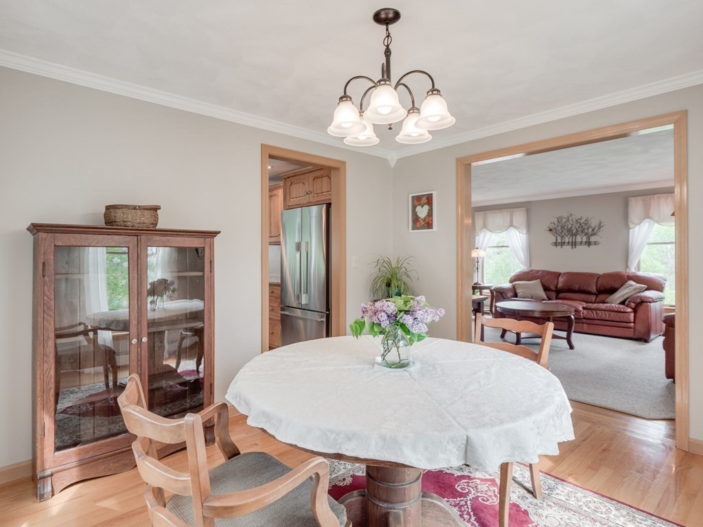 21 Scenic View Drive Pelham, NH 03076 - Photo 14 of 42 a living room with furniture and a chandelier
