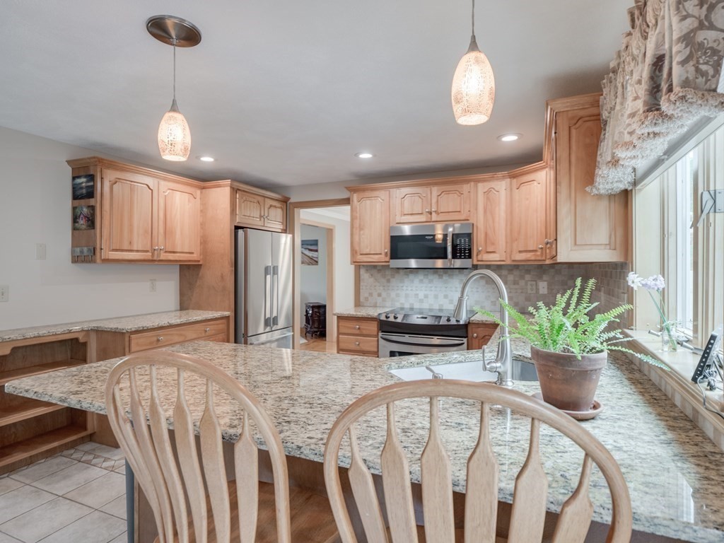 21 Scenic View Drive Pelham, NH 03076 - Photo 20 of 42 a kitchen with sink a refrigerator and chairs