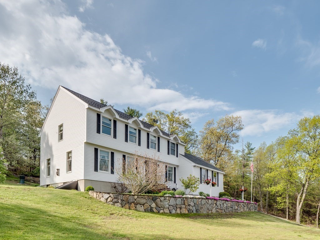 21 Scenic View Drive Pelham, NH 03076 - Photo 2 of 42 a front view of a house with a garden and trees