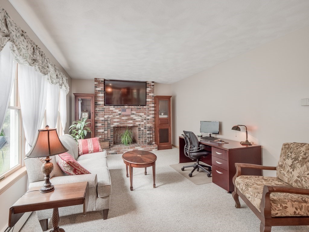 21 Scenic View Drive Pelham, NH 03076 - Photo 24 of 42 a living room with furniture a fireplace and a large window