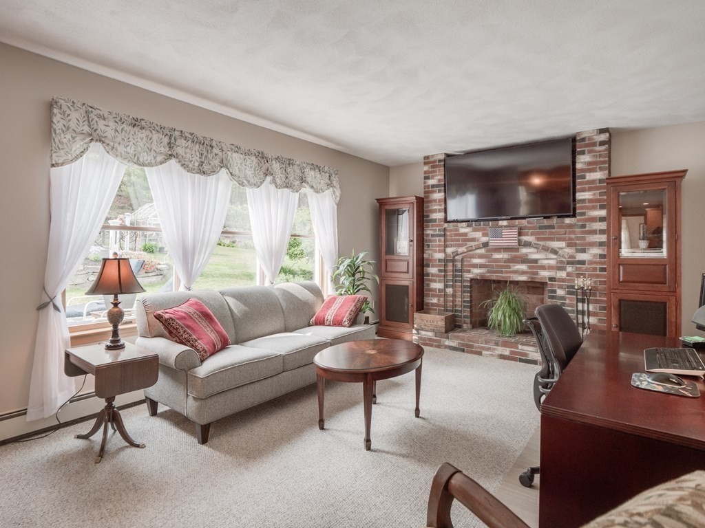 21 Scenic View Drive Pelham, NH 03076 - Photo 25 of 42 a living room with furniture and a fireplace