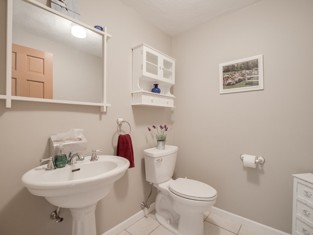 21 Scenic View Drive Pelham, NH 03076 - Photo 28 of 42 a bathroom with a sink mirror and toilet