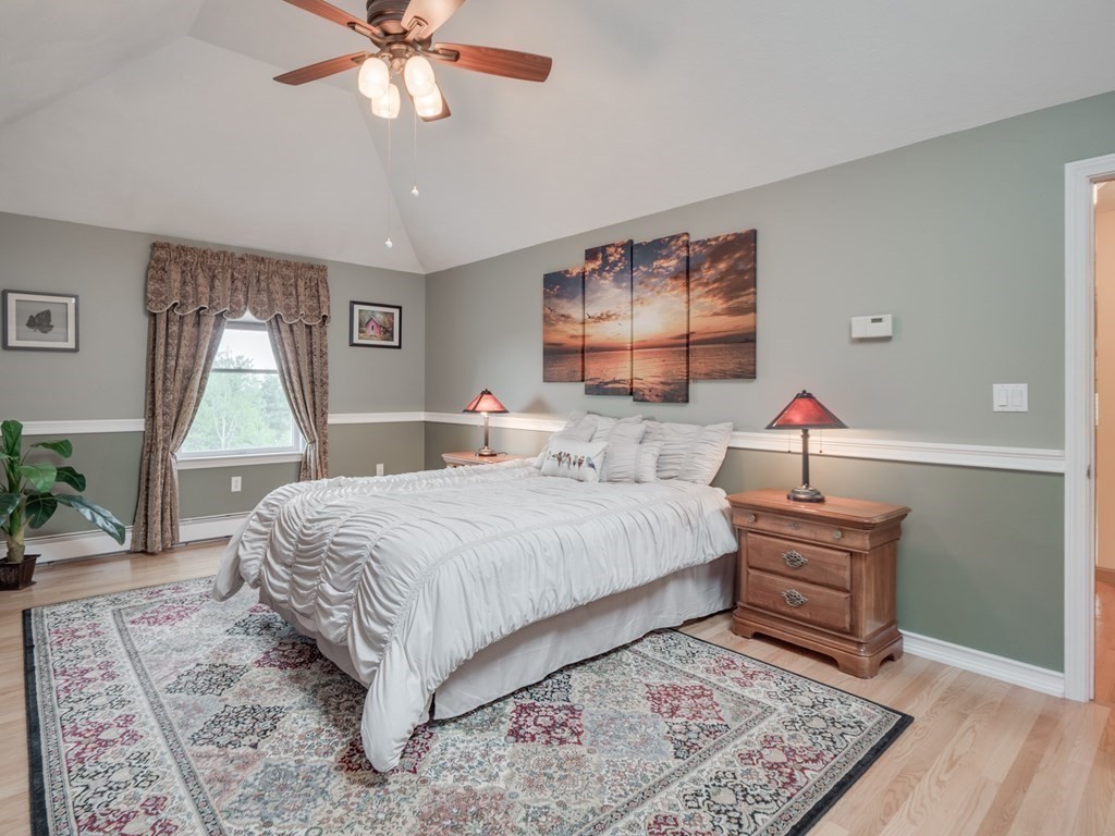 21 Scenic View Drive Pelham, NH 03076 - Photo 32 of 42 a bedroom with a bed and a chandelier