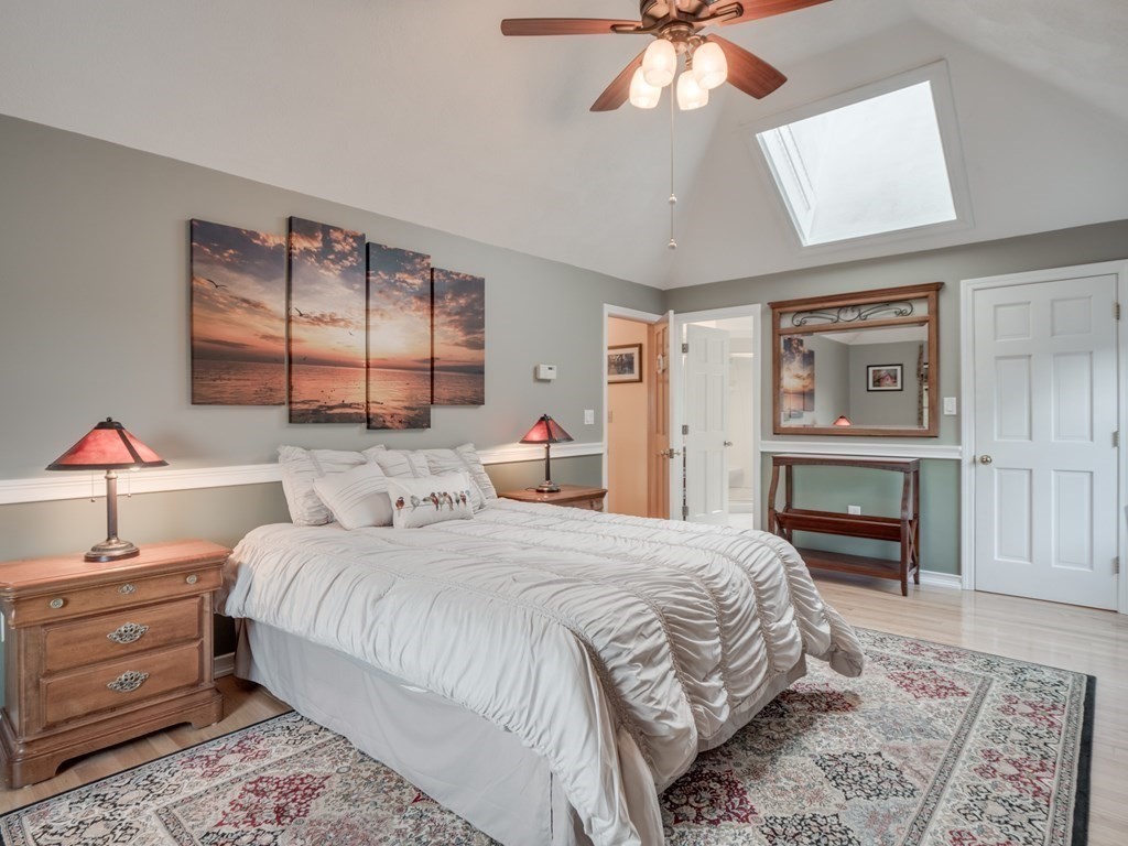 21 Scenic View Drive Pelham, NH 03076 - Photo 33 of 42 a bedroom with a bed and a chandelier