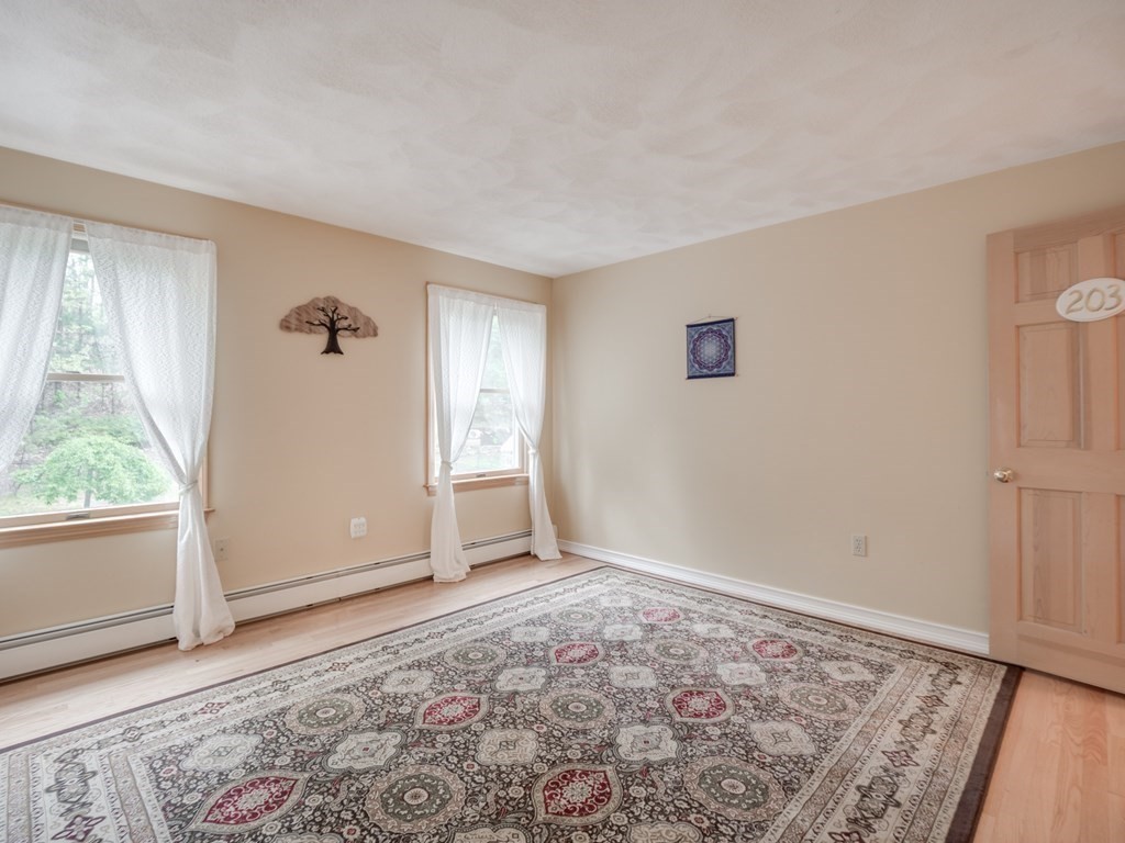 21 Scenic View Drive Pelham, NH 03076 - Photo 40 of 42 a view of empty room with wooden floor and fan