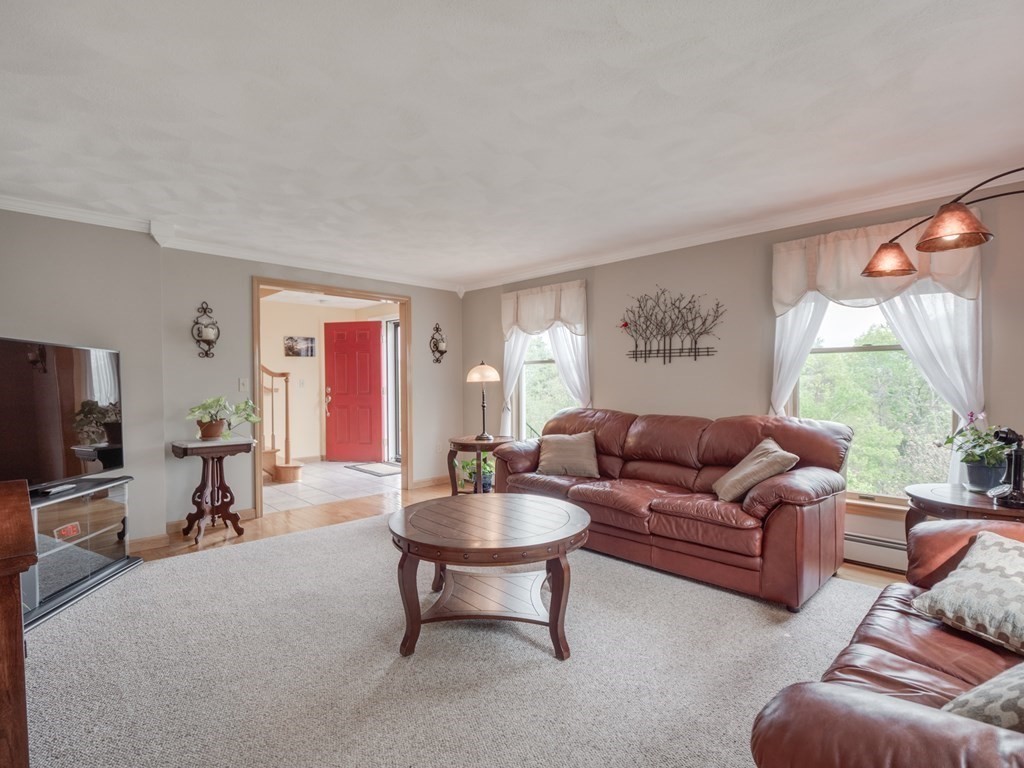 21 Scenic View Drive Pelham, NH 03076 - Photo 10 of 42 a living room with furniture a flat screen tv and a window