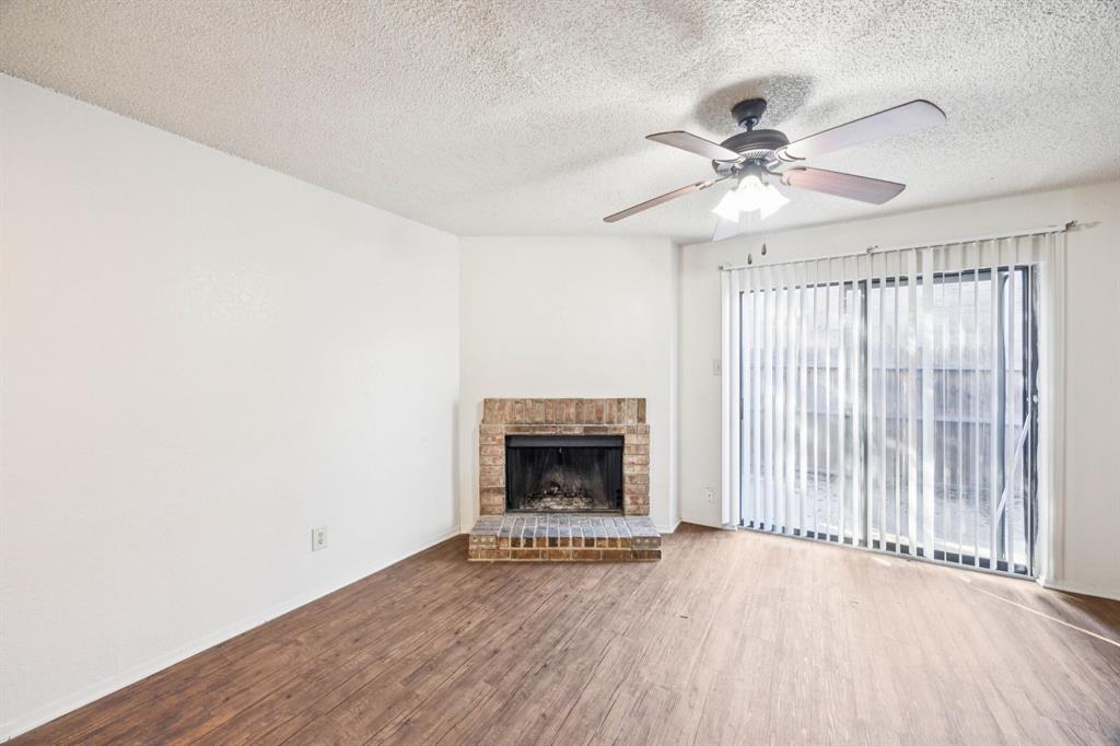 8109 Silver Creek Road, Unit B White Settlement, TX 76108 - Photo 12 of 28 a view of an empty room with a fireplace and a window
