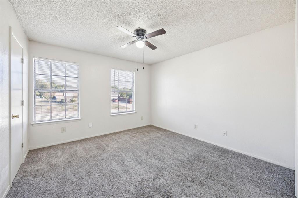 8109 Silver Creek Road, Unit B White Settlement, TX 76108 - Photo 15 of 28 an empty room with windows and chandelier fan