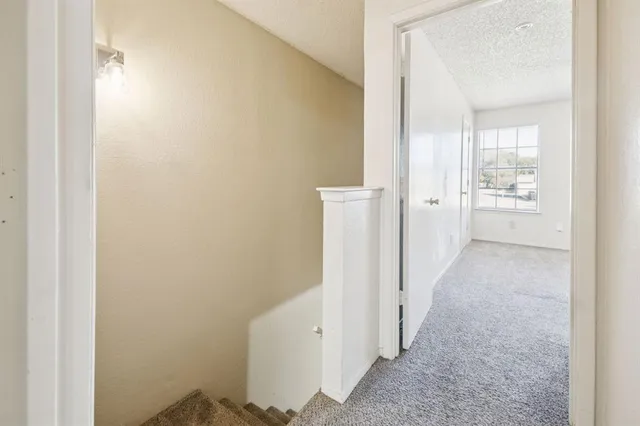 an empty room with closet and a ceiling fan