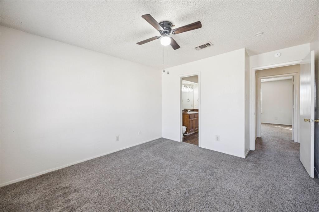 8109 Silver Creek Road, Unit B White Settlement, TX 76108 - Photo 20 of 28 an empty room with closet and a ceiling fan