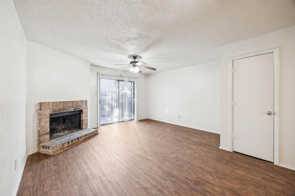 8109 Silver Creek Road, Unit B White Settlement, TX 76108 - Photo 22 of 28 a view of an empty room with wooden floor fireplace and a window