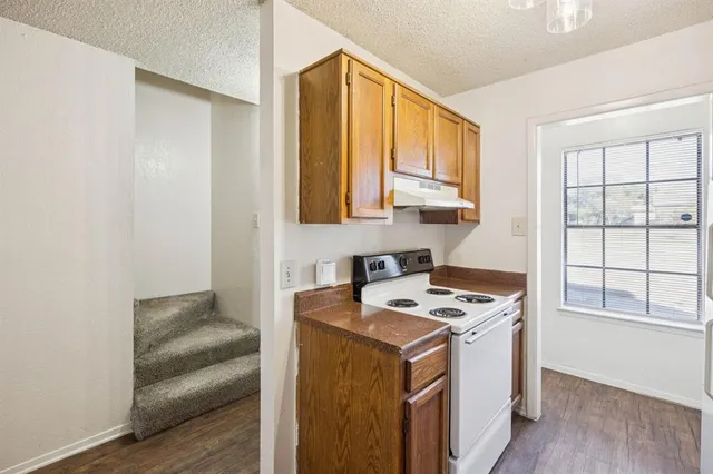 a utility room with cabinets washer and dryer