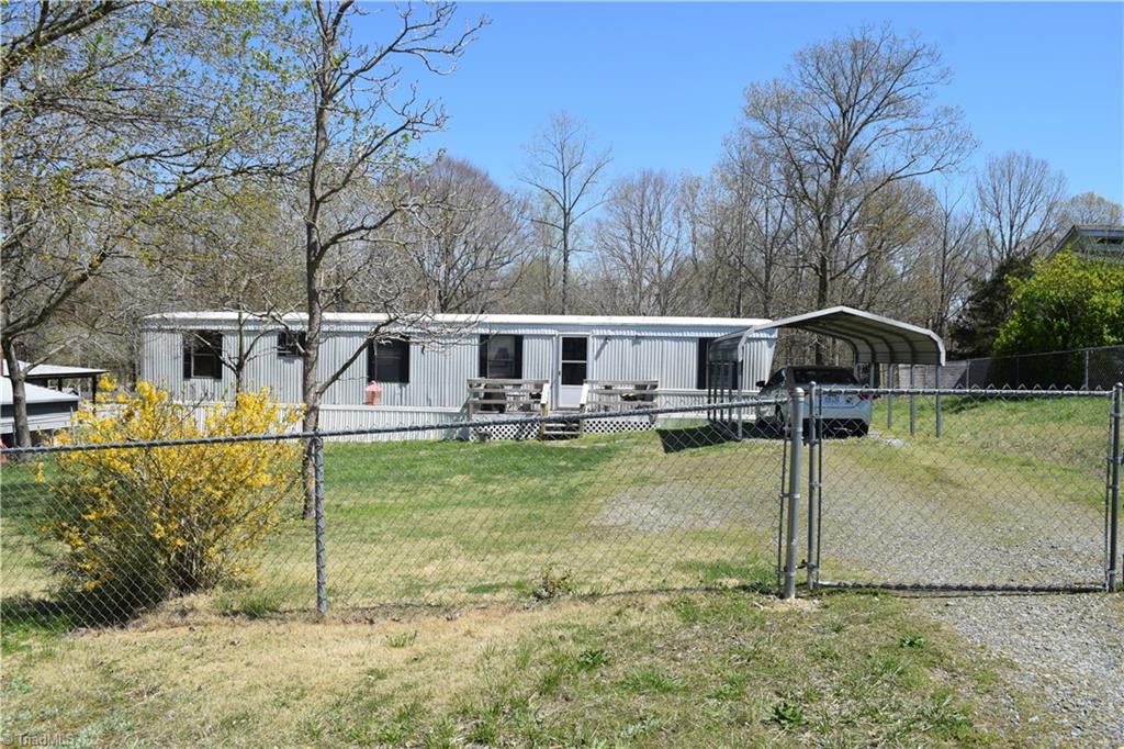 217 Wintbrook Road Thomasville, NC 27360 - Photo 1 of 15 Front of home with fence around entire property