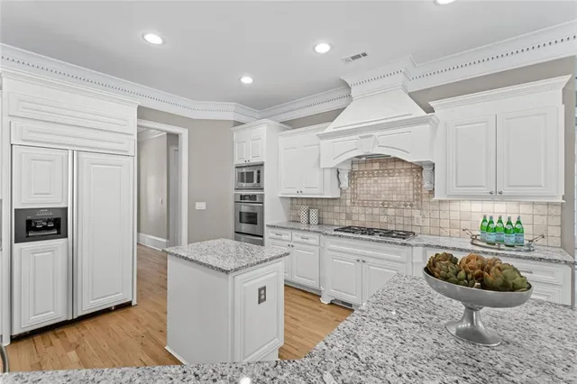 a living room with furniture and view of kitchen