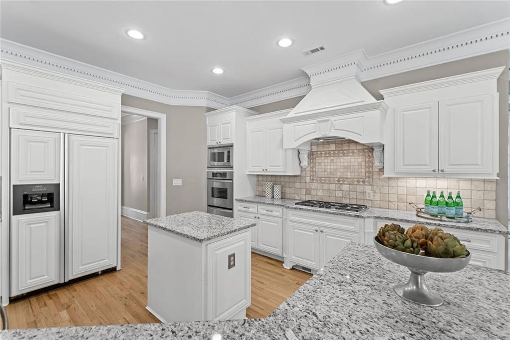 2281 Bransley Place Duluth, GA 30097 - Photo 16 of 70 a kitchen with stainless steel appliances granite countertop a stove a sink and a refrigerator