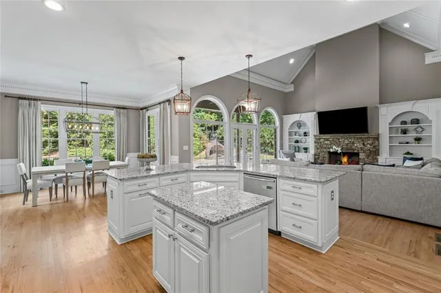 a kitchen with stainless steel appliances granite countertop a stove and cabinets