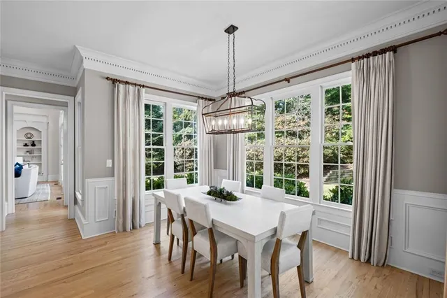 a bathroom with a granite countertop sink a toilet a mirror and shower curtain