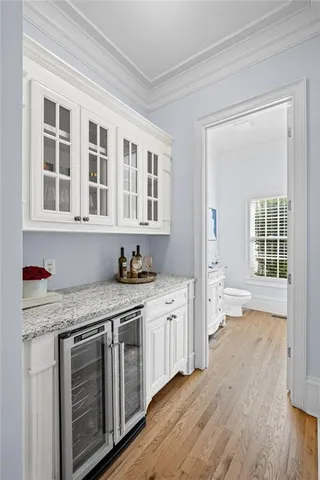 a spacious bedroom with a bed a couch and a chandelier