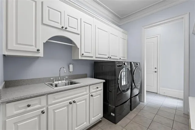 a kitchen with white cabinets and appliances
