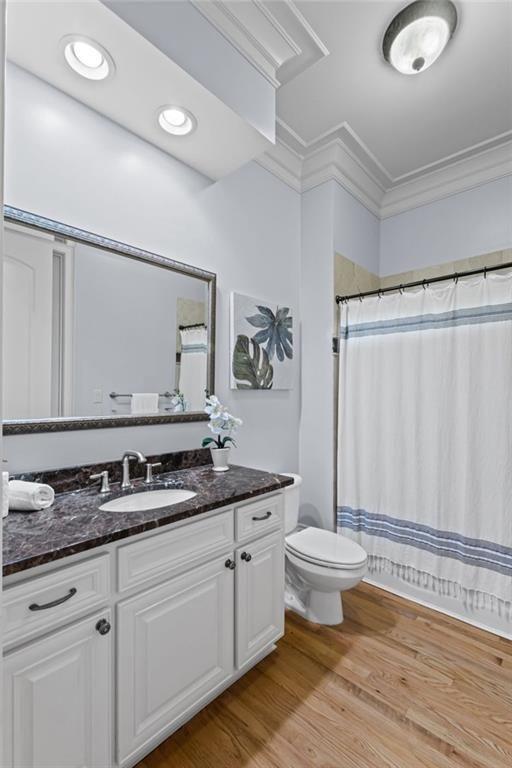 2281 Bransley Place Duluth, GA 30097 - Photo 30 of 70 a bathroom with a granite countertop sink a toilet a mirror and shower curtain