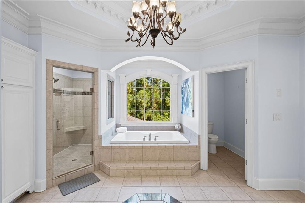 2281 Bransley Place Duluth, GA 30097 - Photo 34 of 70 a bathroom with a bathtub and a shower