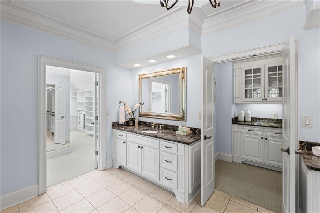 2281 Bransley Place Duluth, GA 30097 - Photo 36 of 70 a kitchen with white cabinets and appliances