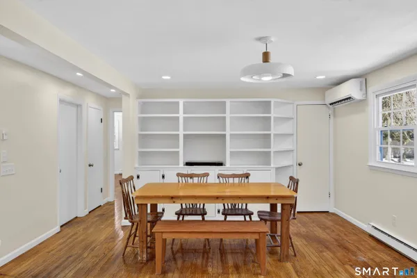 a view of a dining room with furniture and wooden floor