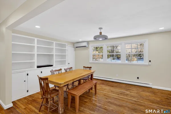a view of a dining room with furniture and wooden floor