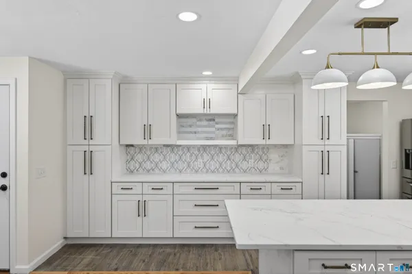 a kitchen with a stove a sink and a refrigerator