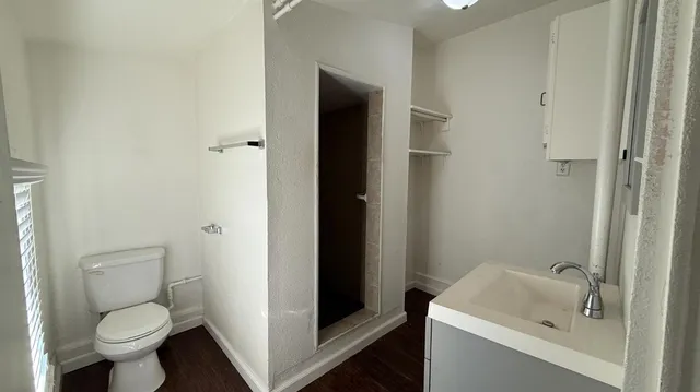 a bathroom with a sink toilet and shower