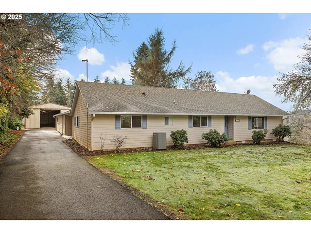 a front view of a house with a garden and yard