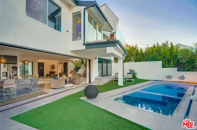 a view of an house with backyard and porch