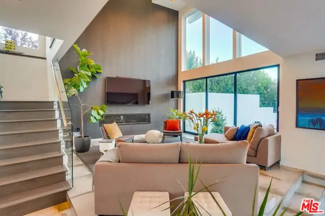 a view of a roof deck with couches and sky view