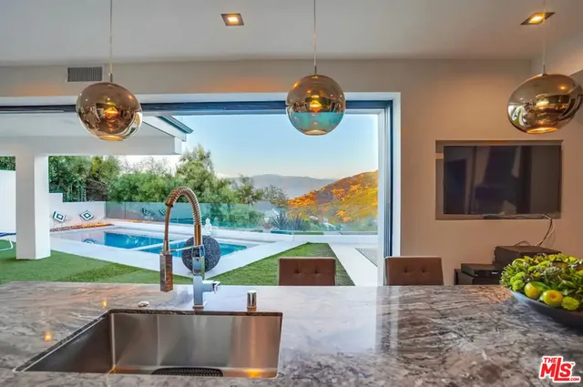 a backyard of a house with table and chairs