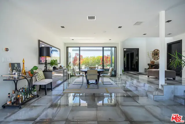 a view of a backyard with a garden and entertaining space