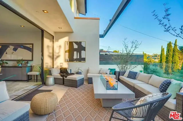 a bedroom with a balcony a bed and a chandelier