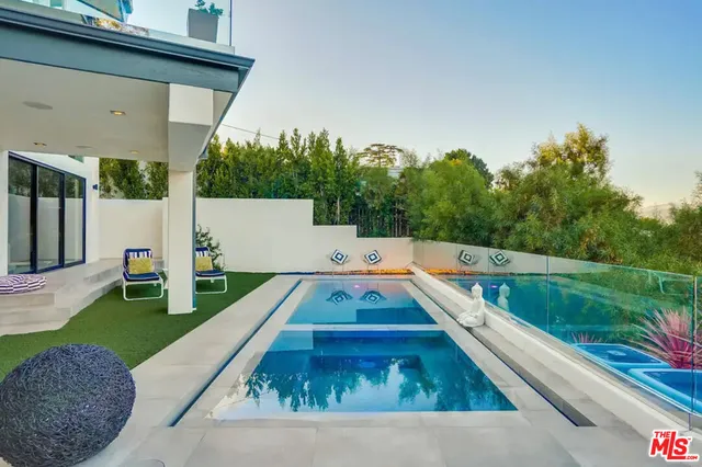a view of a roof deck with couches and sky view