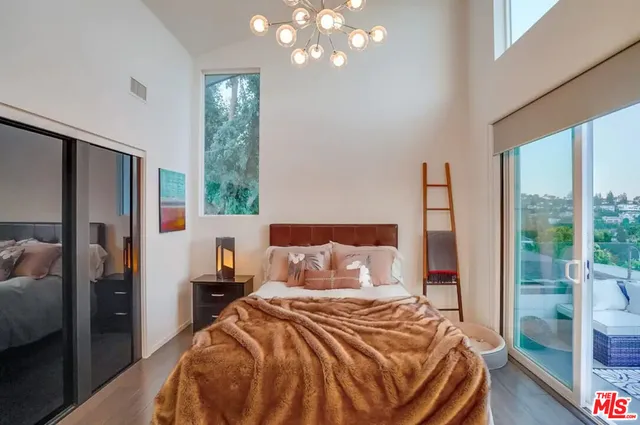 a bedroom with a bed and a painting on the wall