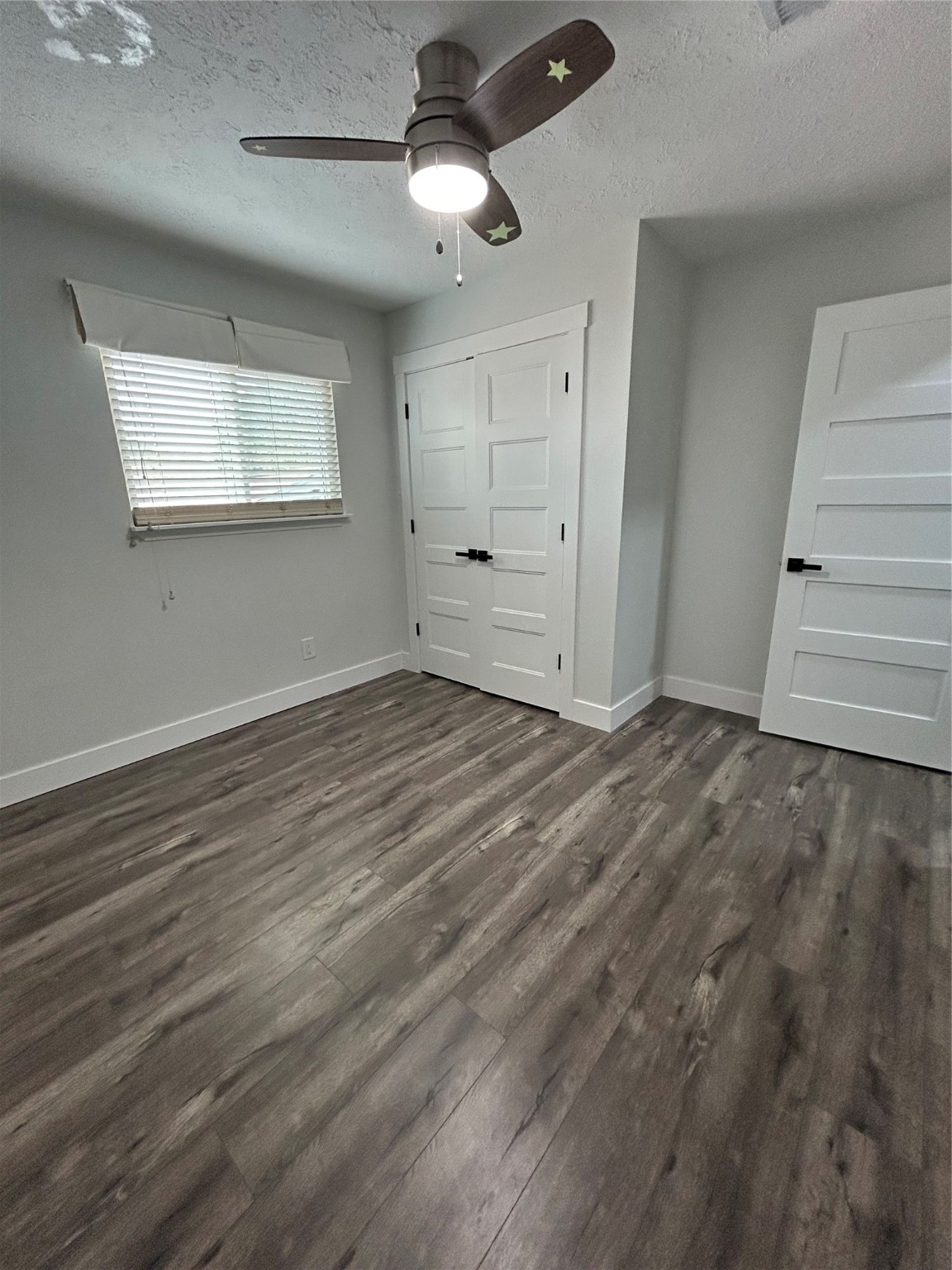 8523 Riverside Walk Lane Houston, TX 77064 - Photo 13 of 24 an empty room with wooden floor ceiling fan and windows