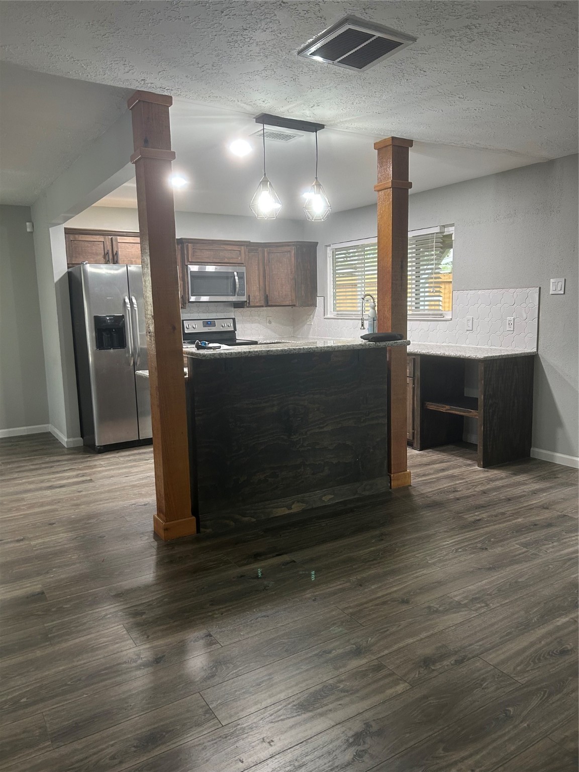 8523 Riverside Walk Lane Houston, TX 77064 - Photo 2 of 24 a kitchen with granite countertop a refrigerator and a stove