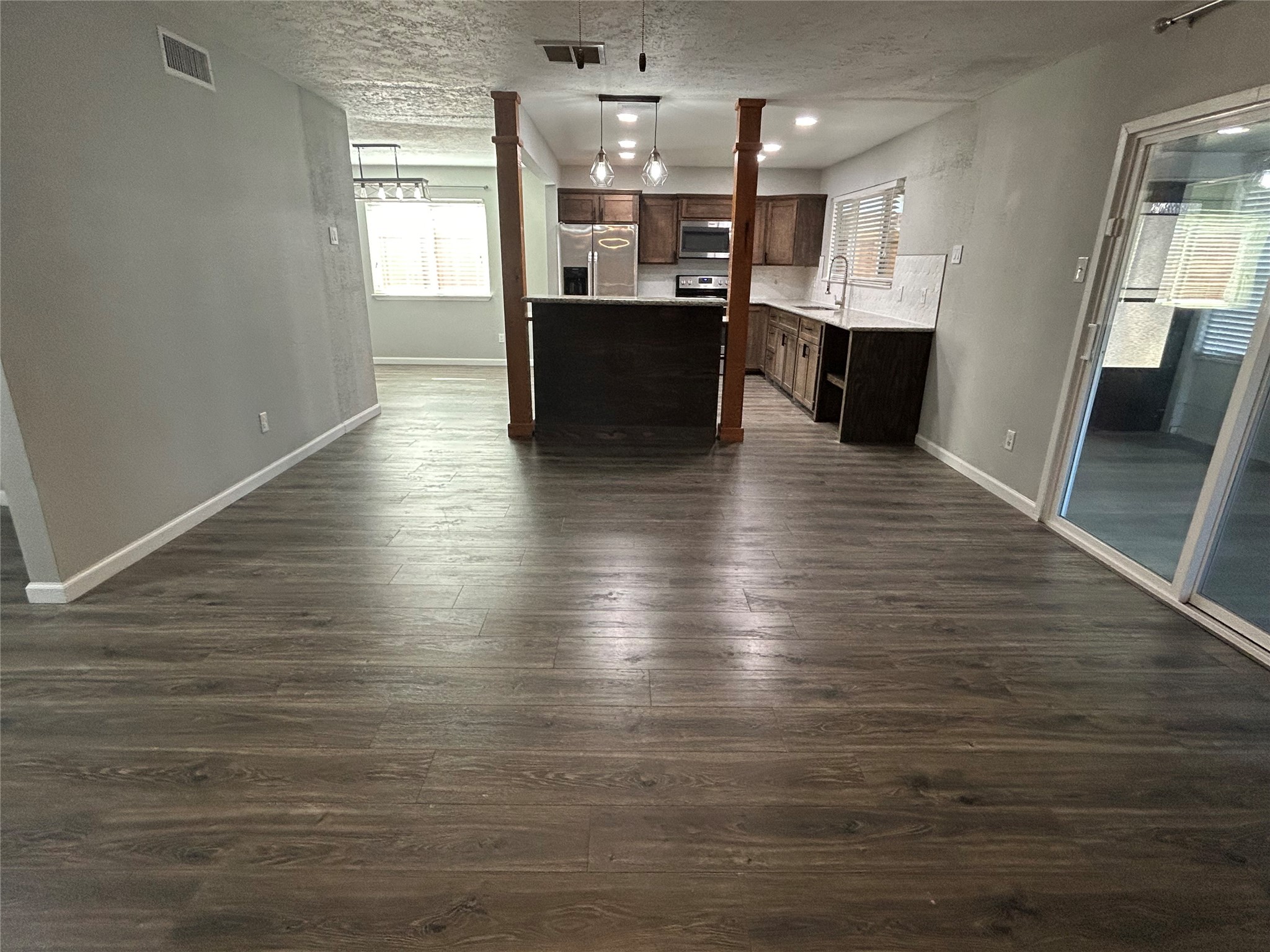 8523 Riverside Walk Lane Houston, TX 77064 - Photo 4 of 24 a view of kitchen and dining room with wooden floor