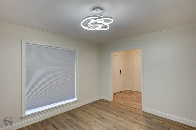 a view of room with wooden floor and ceiling fan