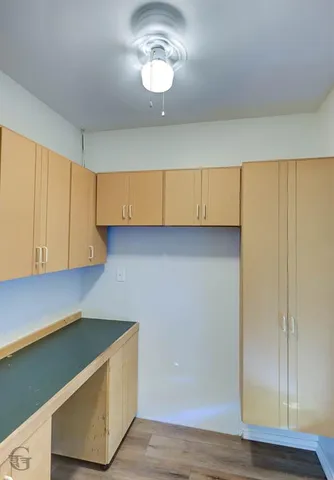 a view of kitchen cabinets and wooden floor