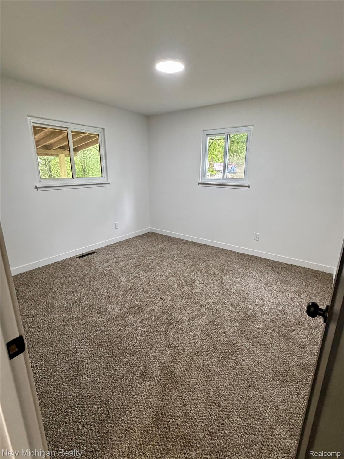 7104 Willard Road Millington, MI 48746 - Photo 20 of 30 Spacious room featuring neutral carpeting and white wall finishes