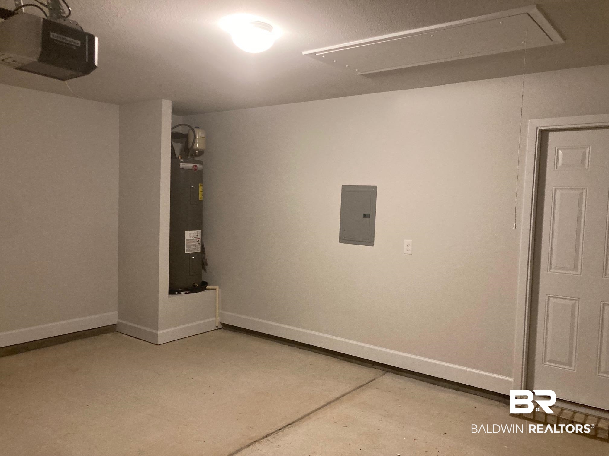 629 Revere Street Foley, AL 36535 - Photo 28 of 30 Garage featuring electric panel, electric water heater, and a garage door opener