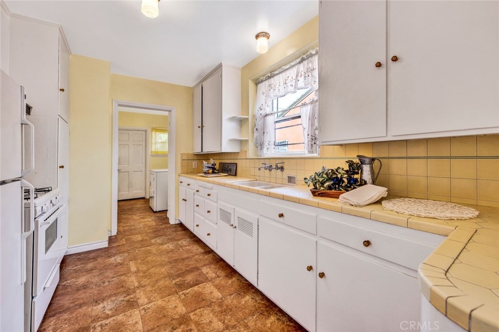 1722 North Flower Street Santa Ana, CA 92706 - Photo 11 of 25 a kitchen that has a lot of cabinets in it
