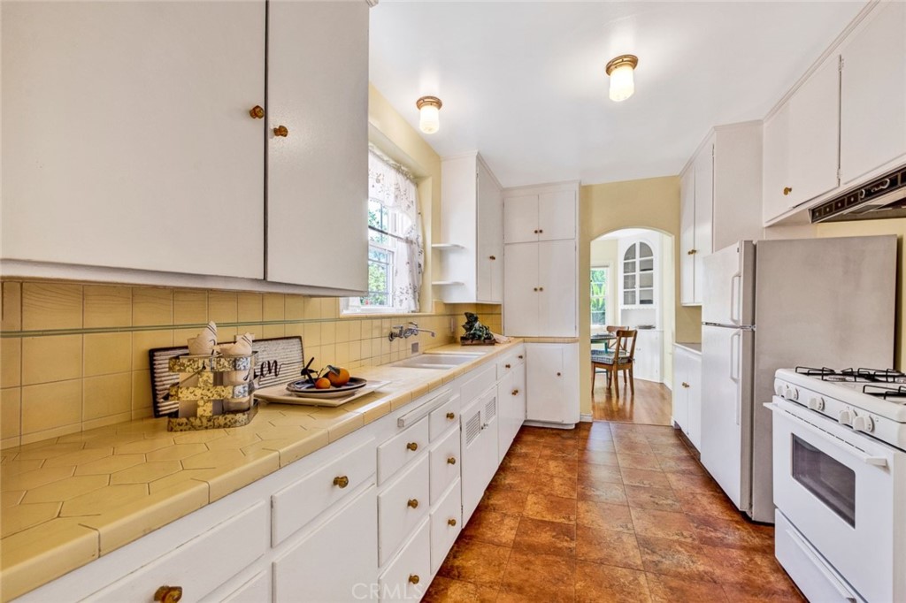 1722 North Flower Street Santa Ana, CA 92706 - Photo 12 of 25 a kitchen with sink a stove and cabinets