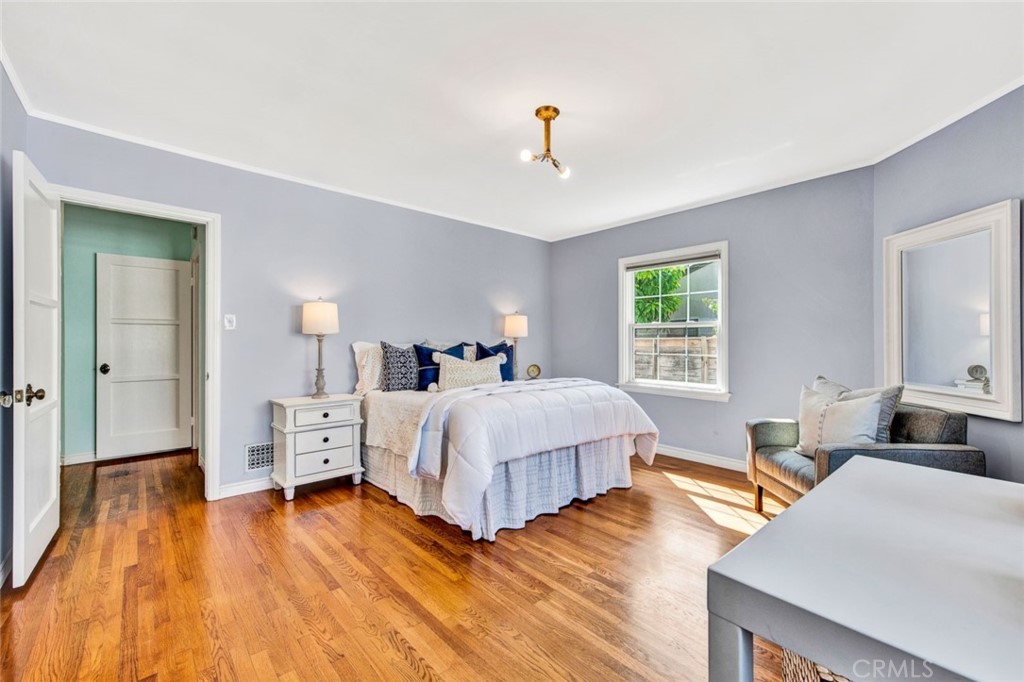 1722 North Flower Street Santa Ana, CA 92706 - Photo 17 of 25 a spacious bedroom with a bed and wooden floor