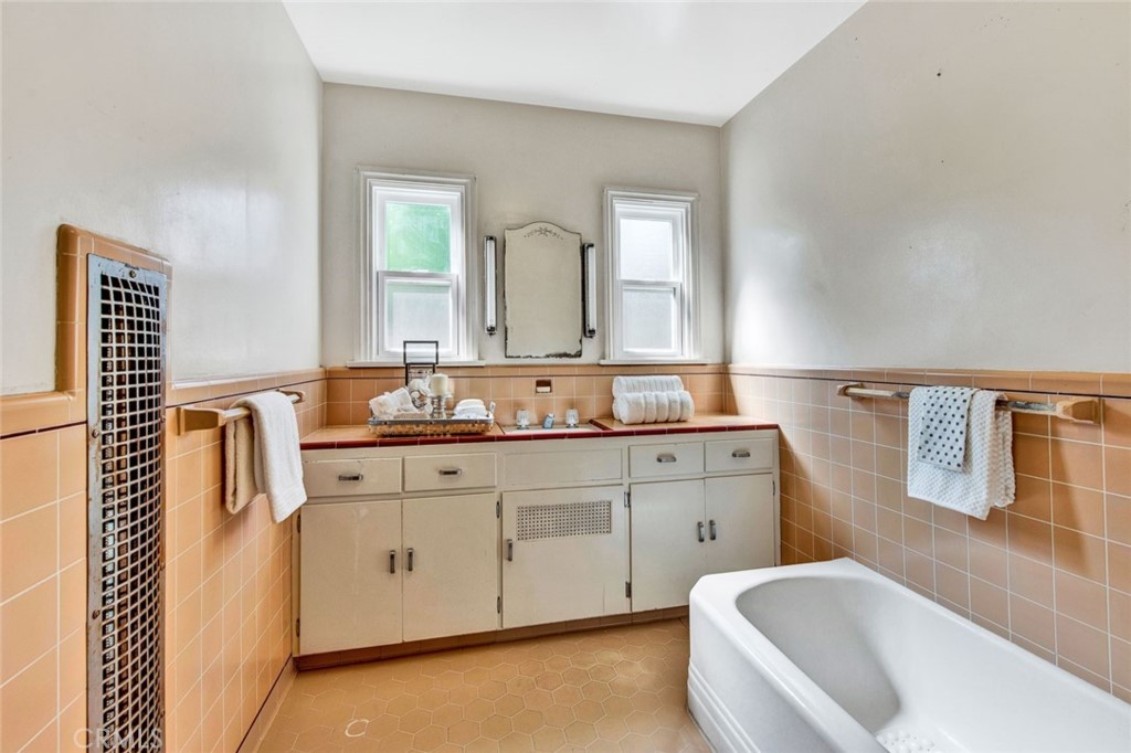 1722 North Flower Street Santa Ana, CA 92706 - Photo 19 of 25 a spacious bathroom with a double vanity sink mirror and bathtub