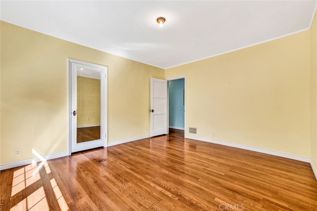 1722 North Flower Street Santa Ana, CA 92706 - Photo 21 of 25 a view of an empty room with wooden floor and a window